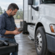 A technician examines a commercial truck module related to preserving truck black box data after a Longview crash.